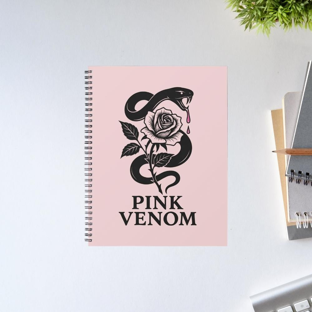 Notebook with 'Pink Venom' design featuring a snake and rose on a pink cover, placed on a light surface. Black Pink Notebook.
