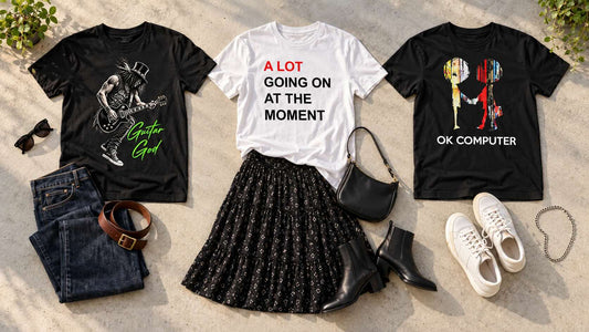 Three band tees laid out with jeans, a skirt and trainers