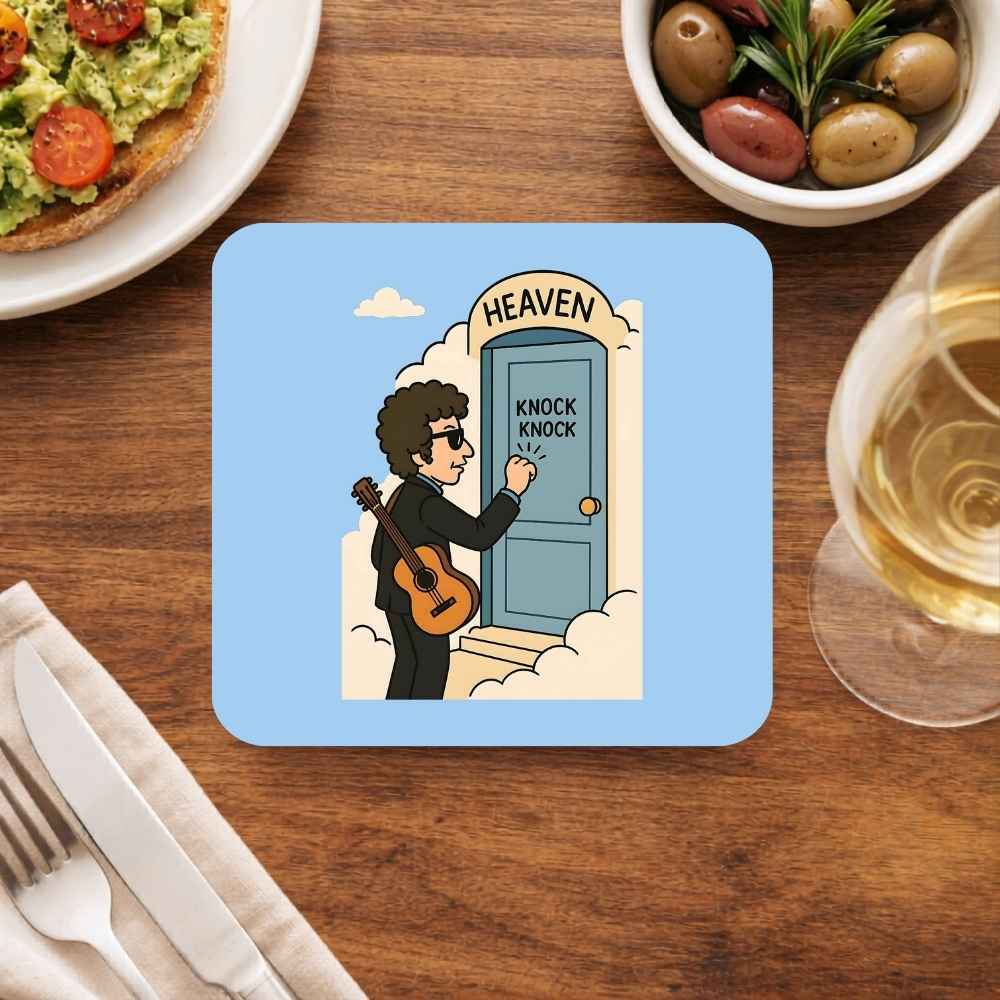 Coaster with a cartoon design of a person with a guitar knocking on a door labeled 'Heaven' on a wooden table with food and drink. Bob Dylan 