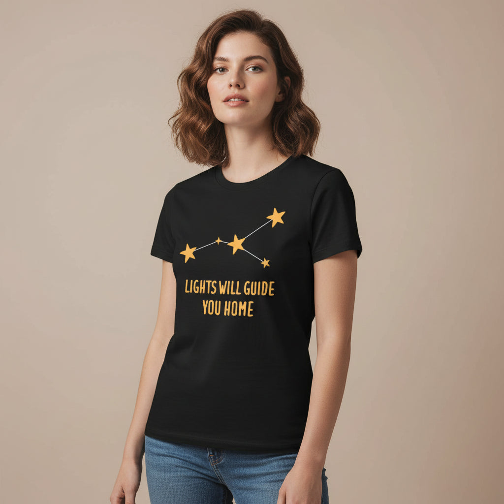 Black t-shirt with yellow star design and text 'LIGHTS WILL GUIDE YOU HOME' on a white background coldplay the bnayan tee 