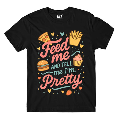 Black t-shirt with colorful graphics and text 'Feed me and tell me I'm pretty' on a white background