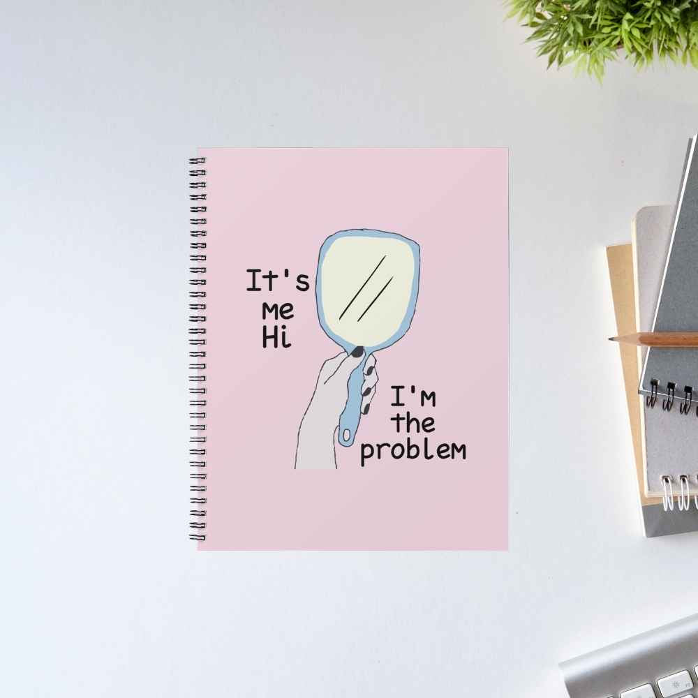 Taylor Swift Anti-Hero spiral notebook with a hand holding a mirror and the lyric "It's me, hi, I'm the problem" on a pink cover – The Banyan Tee